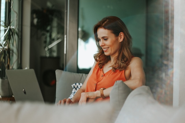 A smiling woman working on her laptop